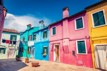 Multicolored houses on Burano island, Venice, Italy, on a summer day. Architecture and travel background.