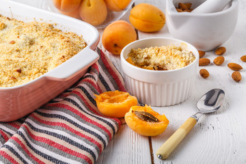 Crumble apricot pie on white table, morning dessert