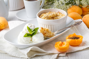 Seasonal fruit crumble dessert with cream ready to serve