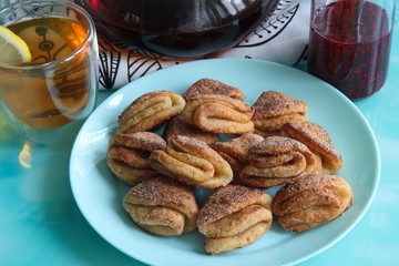 Biscuits with cottage cheese, tea with lemon and raspberry jam