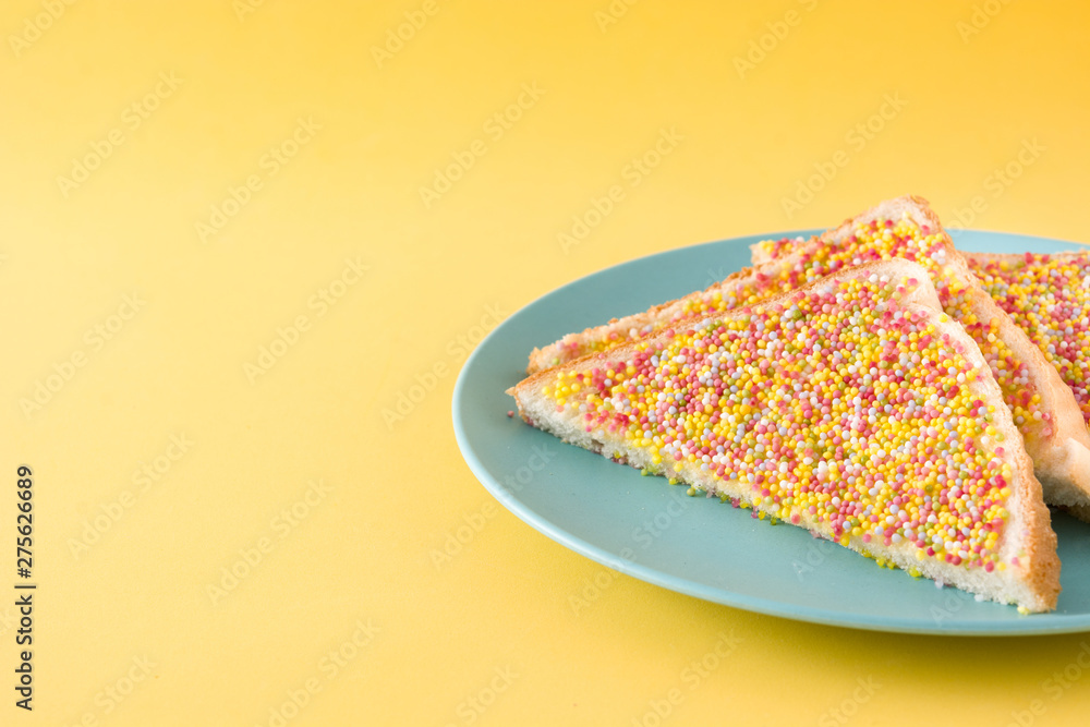 Wall mural Traditional Australian fairy bread on yellow background. Copyspace