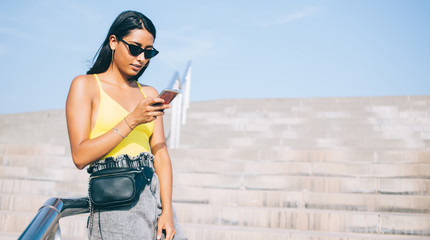 Attractive millennial female blogger creating text publication about internet using, Spanish woman...