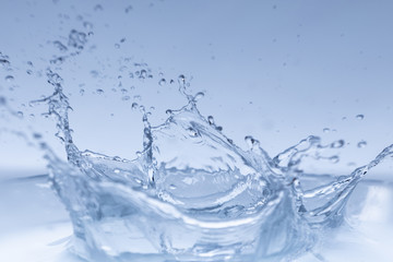 Fototapeta na wymiar water splash isolated on blue background , 