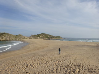 Garden Route Robberg Nature Reserve young man  walking in beautiful beach and ocean Plettenberg Bay South Africa.