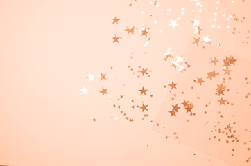 Bright coral background with shiny stars.