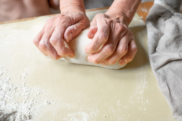 Closeup portrait of kids and adult hands making dough for pastry 