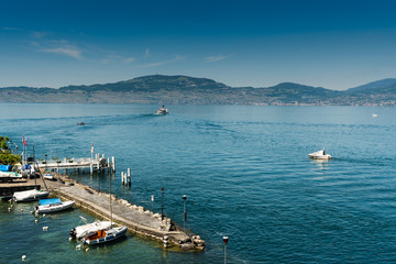 ships leaving and entering Saint-Gingolph Harbor on Lake Geneva on a beautiful summer day