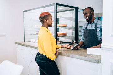 Black woman paying for order in cafe