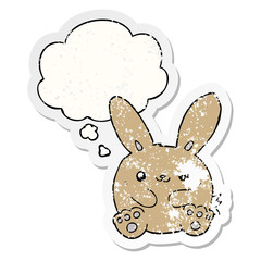 cartoon rabbit and thought bubble as a distressed worn sticker