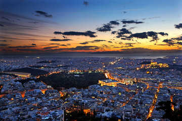 Fototapeta na wymiar Panoramic view of Athens city from Lycabettus hill, after sunset. To the right you can see the Acropolis, close to the center of the photo, the Parliament and on the left side the Panathenaic stadium