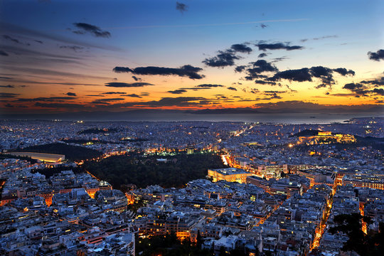 Panoramic view of Athens city from Lycabettus hill, after sunset. To the right you can see the Acropolis, close to the center of the photo, the Parliament and on the left side the Panathenaic stadium