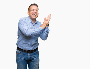 Middle age arab business man over isolated background Clapping and applauding happy and joyful, smiling proud hands together
