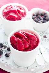Blackcurrant sorbet in white cups, selective focus