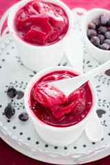 Blackcurrant sorbet in white cups, selective focus