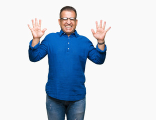 Middle age arab man wearing glasses over isolated background showing and pointing up with fingers number ten while smiling confident and happy.