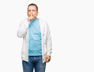 Middle age arab man wearing sweatshirt over isolated background asking to be quiet with finger on lips. Silence and secret concept.