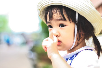 Outdoor Portrait of Little asian girl Wearing boater