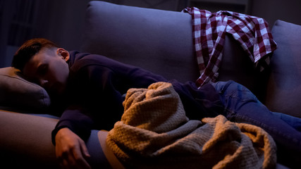 Tired student sleeping in clothes after party, idle life and exhaustion