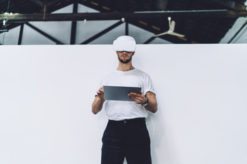 Skilled man typing with digital pencil for interactive touch over tablet for creating augmented 3d...