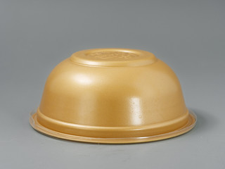 disposable dishes for fast food. bowl with lid and fork. on gray background