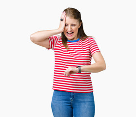 Middle age mature woman wearing casual t-shirt over isolated background Looking at the watch time worried, afraid of getting late