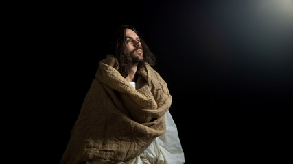 Biblical prophet in robe looking at light, belief spirituality and religion