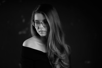 black and white photo of a girl in glasses / classic glasses girl portrait of a strict businesswoman concept