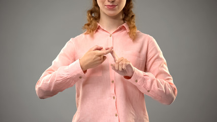 Woman saying friend in sign language, showing words in asl lesson, communication