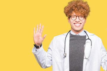 Young handsome doctor man wearing medical coat showing and pointing up with fingers number nine while smiling confident and happy.