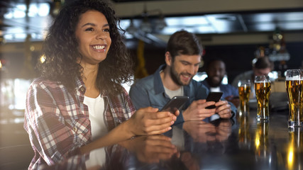 Joyful female happy about winning bet on sports game in pub, celebrating victory - Powered by Adobe