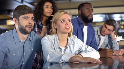 Unhappy young people disappointed with favorite team loss in sport event