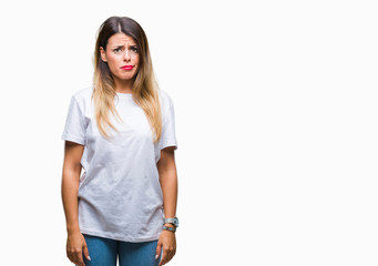 Fototapeta premium Young beautiful woman casual white t-shirt over isolated background skeptic and nervous, frowning upset because of problem. Negative person.