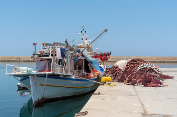 Chania, Crete, Greece, June 2019. A commercial fishing boat and nets alongside in Chania fishing port, Greece.