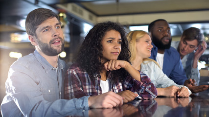 Disappointed team supporters watching championship together, fans enthusiasm