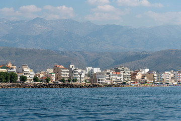 Fototapeta na wymiar Chania, Crete, Greece. June 2019. The coastal landscape of Chania northern Crete showing hotels and homes with a backdrop of mountains