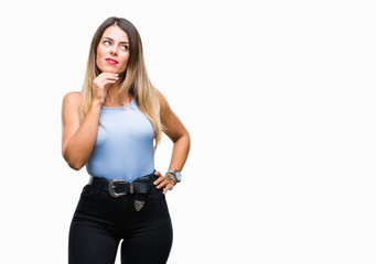 Young beautiful elegant business woman over isolated background with hand on chin thinking about question, pensive expression. Smiling with thoughtful face. Doubt concept.