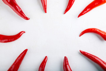 Red pepper frame on white background. Top view,  copy space, flat lay, close-up. Ramiro pepper.