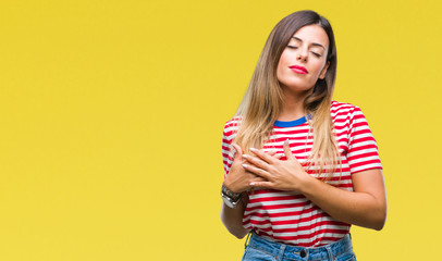 Young beautiful woman casual look over isolated background smiling with hands on chest with closed eyes and grateful gesture on face. Health concept.