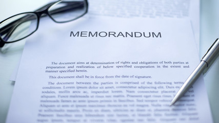 Memorandum lying on table, pen and eyeglasses on official document, business - obrazy, fototapety, plakaty