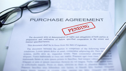 Purchase agreement pending, seal stamped on official document, business contract