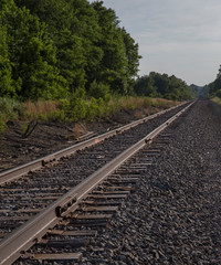 Obraz premium railway leading into the blue sky and woods 