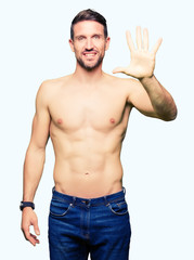 Handsome shirtless man showing nude chest showing and pointing up with fingers number five while smiling confident and happy.