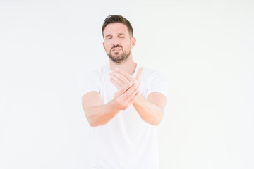Young handsome man wearing casual white t-shirt over isolated background Suffering pain on hands and fingers, arthritis inflammation