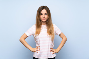 Young woman over isolated blue background angry