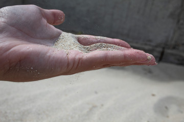 Sand in female hands. There is free space.