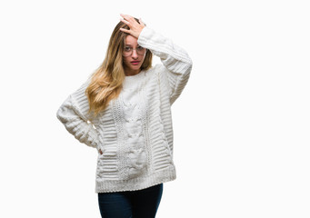 Young beautiful blonde woman wearing winter sweater and sunglasses over isolated background...