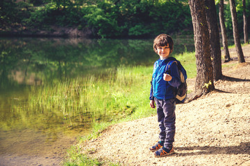 Child play fishing near lake.