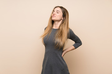 Fototapeta premium Young woman over isolated background suffering from backache for having made an effort
