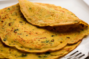 Chilla or Besan cheela is a simple pancake made with chickpea flour and some basic ingredients served with green chutney and tomato sauce, also known as veg-omelette