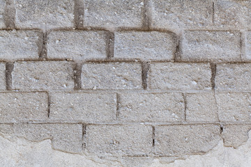 Light white brick wall with big block.